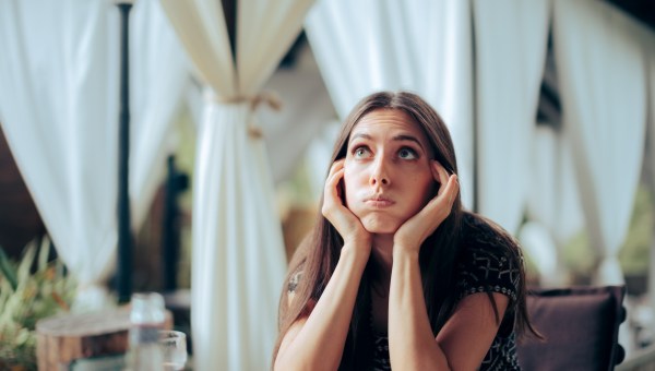 Unhappy young woman at event