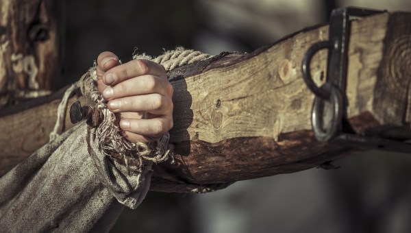 A hand nailed to a cross