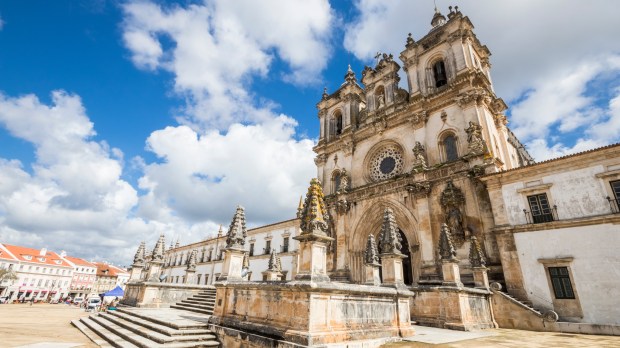 Main-facade-of-the-Alcobaca-Monastery-Mosteiro-de-Santa-Maria-in-Portugal-in-gothic-and-baroque-architecture.-A-World-Heritage-Site-since-1997.jpeg