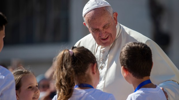 Pope Francis meets children as he arrives for his weekly general audience in St. Peter's Square at the Vatican