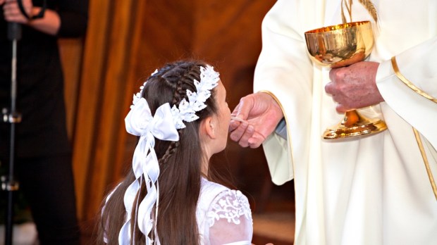 Girl receiving her First Holy Communion