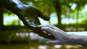 Rodin sculpted hand touched by human hand