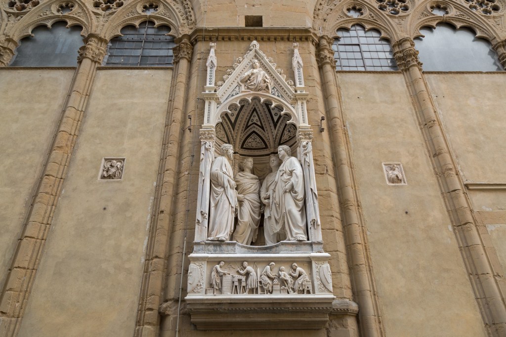 FLORENCE-ITALY-SEPTEMBER-2016-Statue-of-4-Crowned-Martyrs-of-Four-Saints-Group-Guild-of-Stone-and-Wood-Masters-by-Nanni-di-Banco-Church-niche-figures-in-Florence-Italy-on-September-21-2016-.jpeg