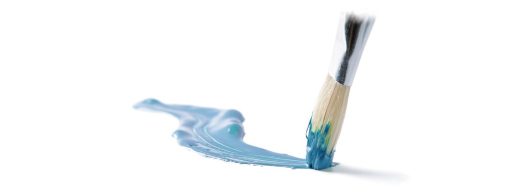 Paintbrush making blue paint stroke