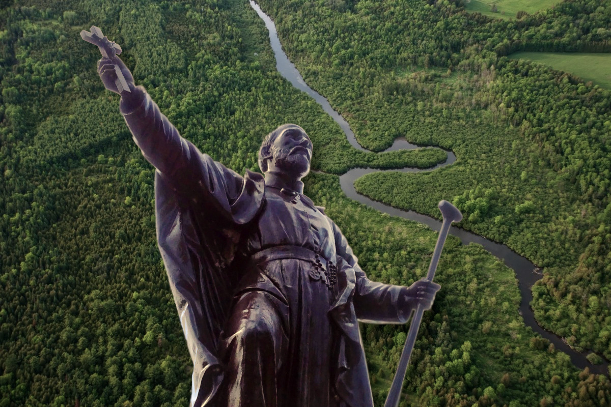 St. Jean de Brebeuf statue against Canadian wilderness.