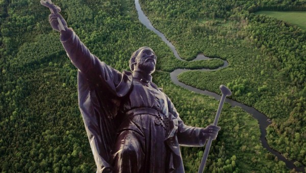 St. Jean de Brebeuf statue against Canadian wilderness.