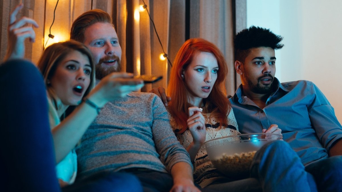 Friends watching a movie together at home