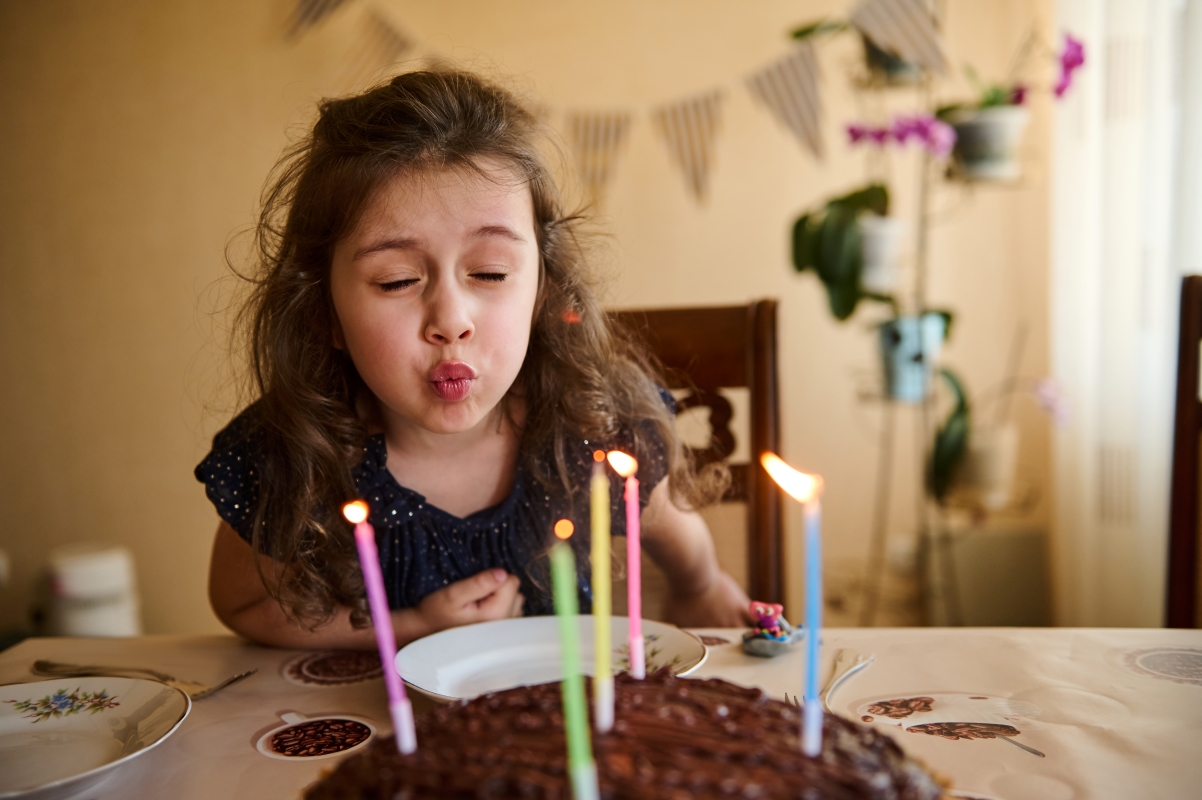 Girl blowing out candles
