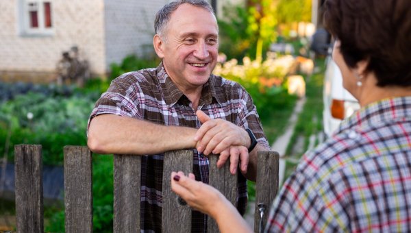Neighbors talking across fence