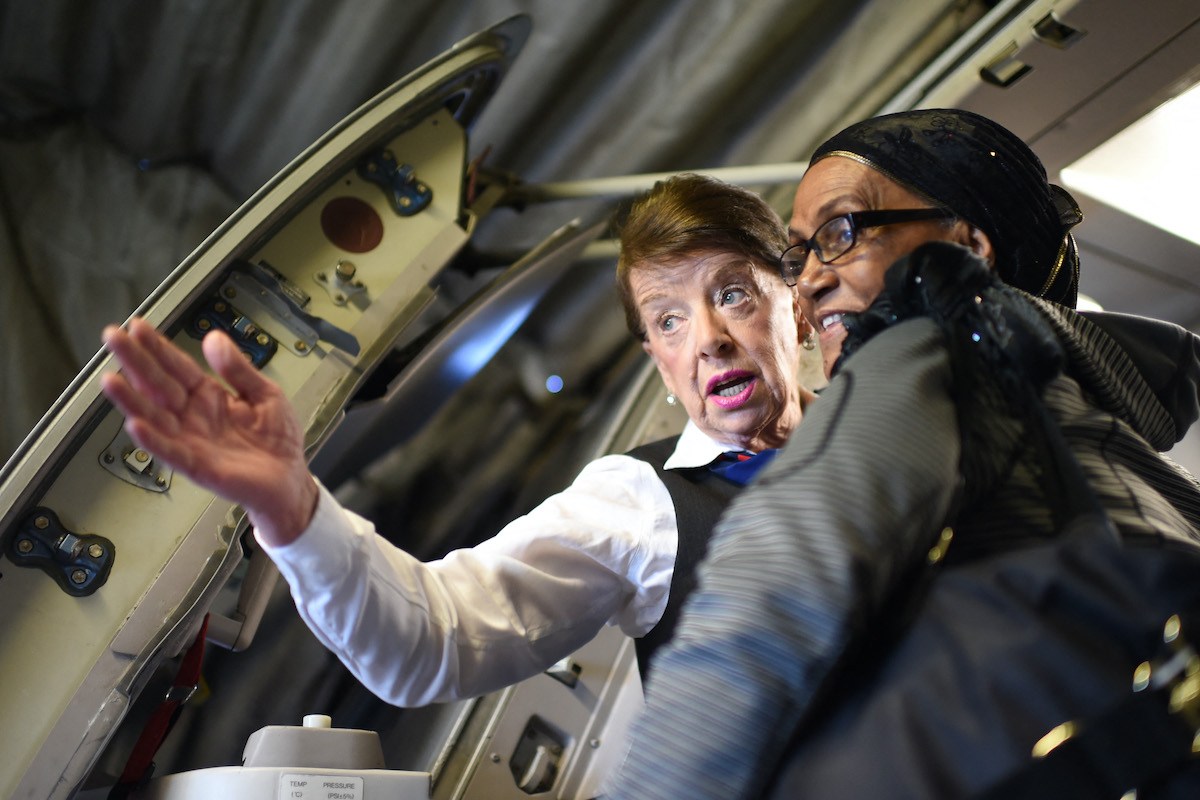 Flight attendant Bette Nash helps flier