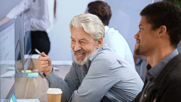 Older worker mentoring a younger worker