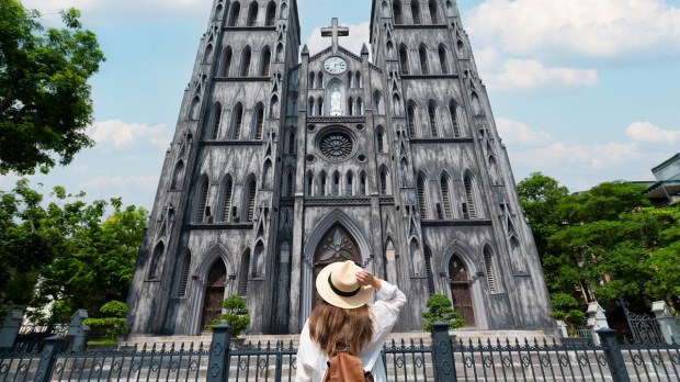 Young woman admires vietnamese church