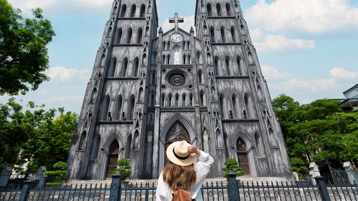 Young woman admires vietnamese church
