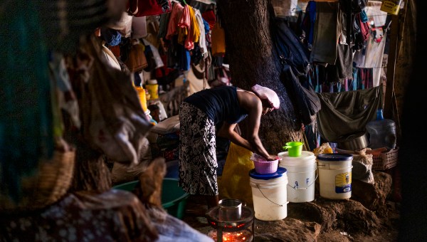 Woman washing utensils in Haiti