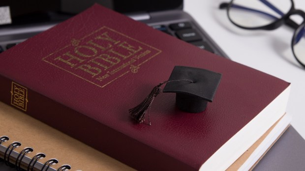 Holy Bible with Graduation cap