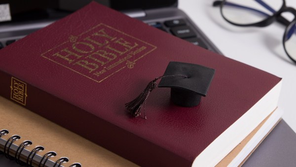 Holy Bible with Graduation cap