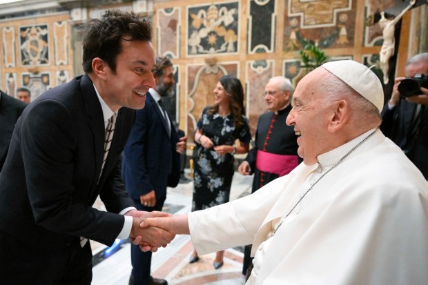 This photo taken and handout on June 14, 2024 by The Vatican Media shows Pope Francis shaking hand with US actor Jimmy Fallon as part of an audience with comedians in The Vatican.
