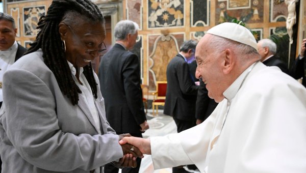 This photo taken and handout on June 14, 2024 by The Vatican Media shows Pope Francis shaking hand with US actress Whoopi Goldberg as part of an audience with comedians in The Vatican.