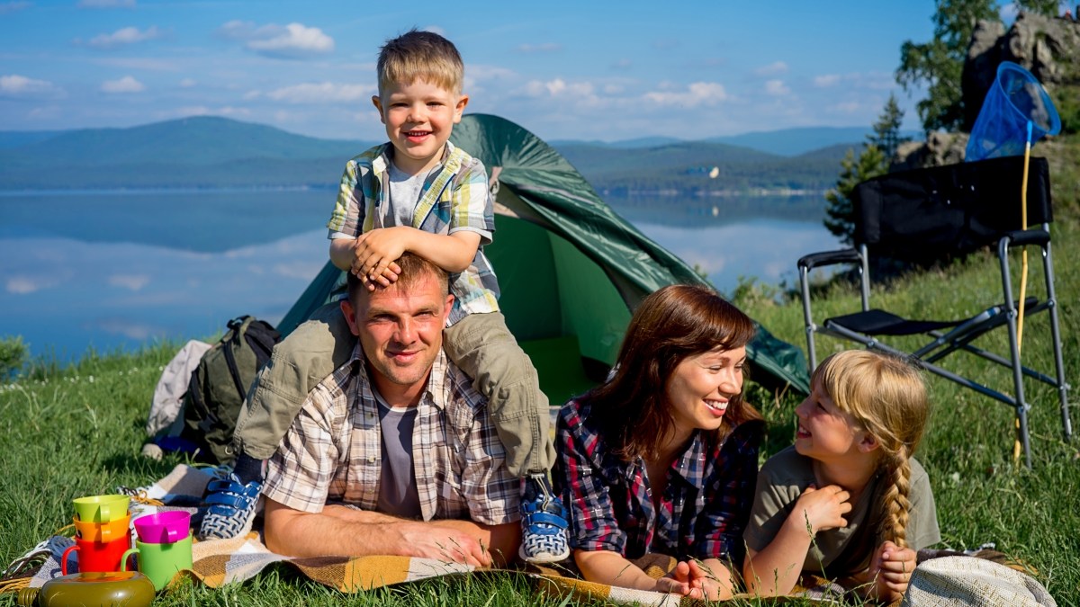 Friendly family outdoors with tent