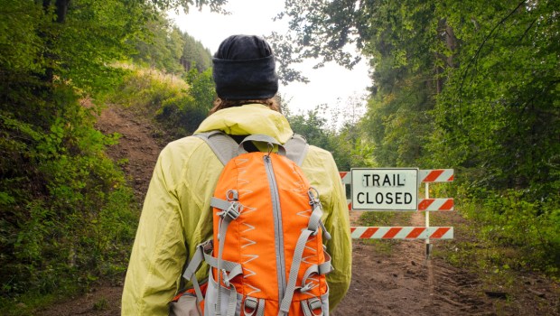 Man on trail going outside comfort zone