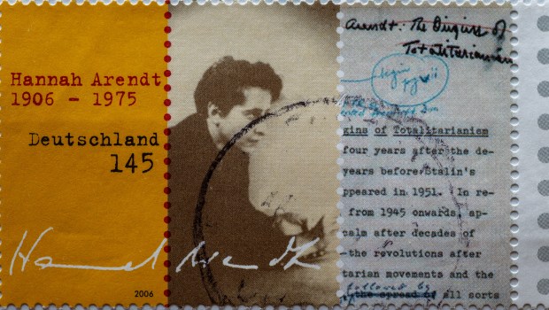 a postage stamp printed in Germany showing a portrait and writings on the 100th birthday of political theorist and publicist Hannah Arendt