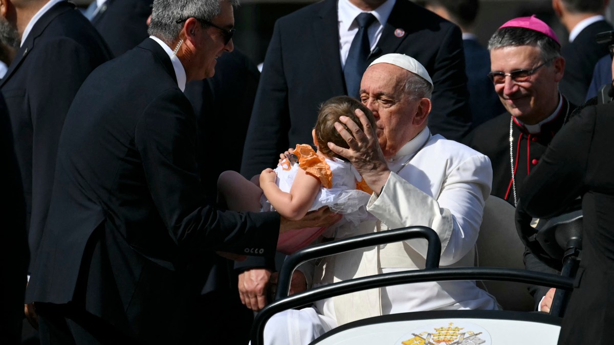 Pope Francis waves to the crowd as he arrives to lead a mass during a pastoral visit on the occasion of the 50th Social Week of Italian Catholics