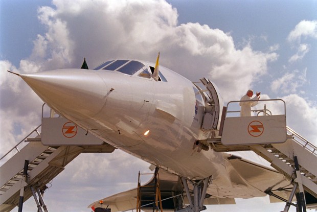 Pope John Paul II waves to wellwishers 02 May 1989 as he disembarks from a Concorde jet liner at Lusaka airport