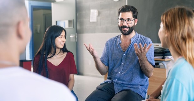 Teacher in a discussion with students