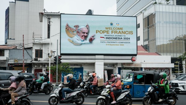 A welcome message is displayed on an electric billboard prior to the arrival of Pope Francis near the Vatican embassy in Jakarta