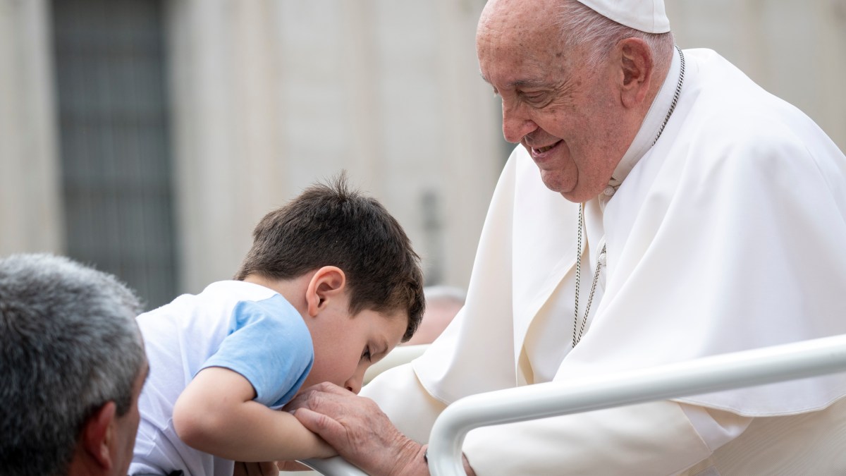 Pope Francis greets a boy at the end of the weekly general audience on September 18, 2024 at St Peter's square in The Vatican.
