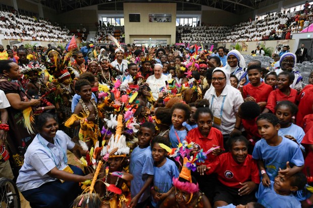 Pope Francis poses with attendees during his visit to Children of Street Ministry and Callan Services at the Caritas Technical Secondary School in Port Moresby on September 7, 2024.
