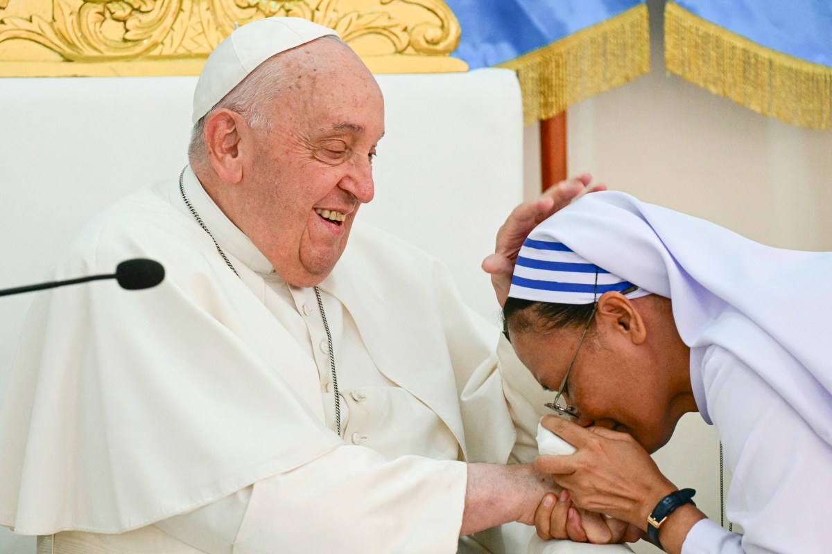 Pope Francis (L) is greeted as he visits the Irmas Alma School for Children with Disabilities in Dili on September 10, 2024.