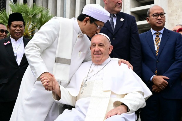 Grand Imam of Istiqlal Mosque Nasaruddin Umar (L) shakes hands with Pope Francis after an interreligious meeting with religious leaders at the Istiqlal Mosque in Jakarta on September 5, 2024.