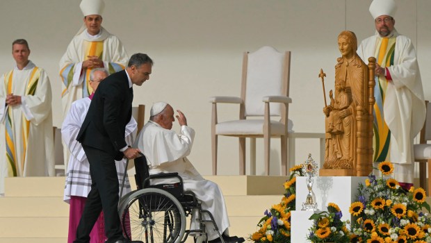 Pope Francis exits the stage on a wheelchair after a holy mass at King Badouin stadium, in Brussels on September 29, 2024.