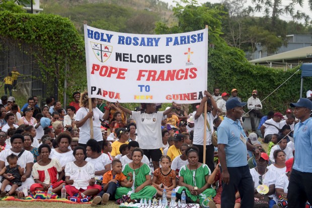 People wait for the arrival of Pope Francis outside the Port Moresby International airport on September 6, 2024.