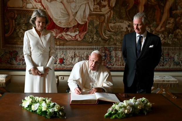 Pope Francis signs the Book of Honour next to King Philippe and Queen Mathilde of Belgium-Castle of Laeken-Belgium