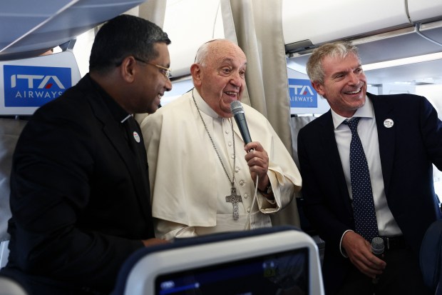 Pope Francis speaks to the media aboard his flight bound for Luxembourg, where he will start a four-day apostolic journey in Luxembourg and Belgium, on September 26, 2024