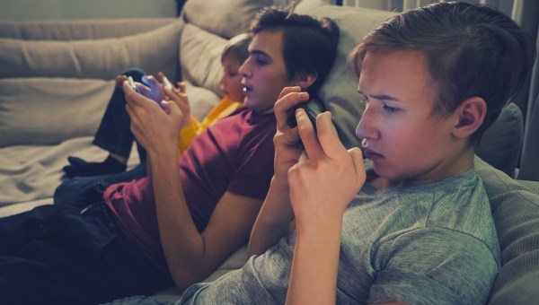 Male teenagers absorbed in their phones