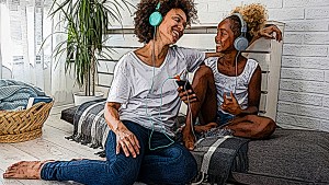 Mom and daughter listening on headphones