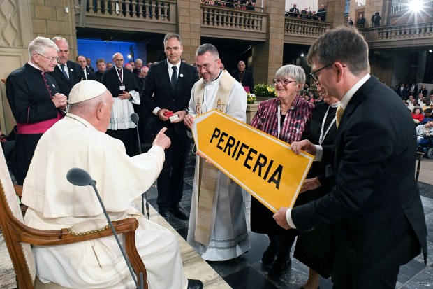 Pope-Francis-L-receives-a-road-sign-during-a-meeting-with-members-of-the-Catholic-community-at-the-Notre-Dame-Cathedral-in-Luxembourg-City