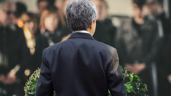 Man delivering a eulogy from behind