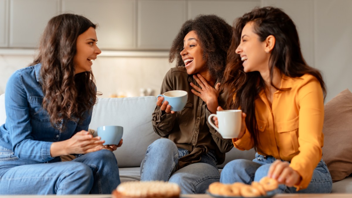 3 women laughing and conversing
