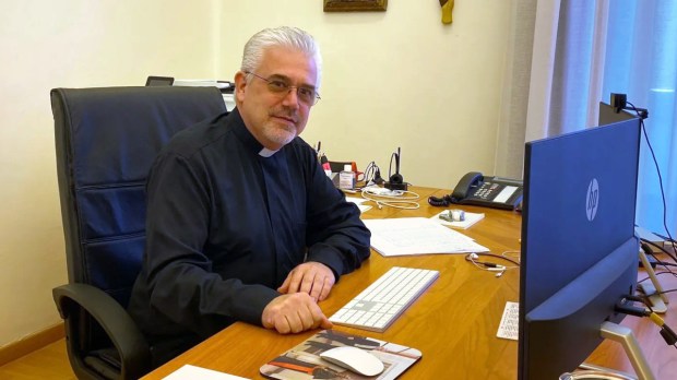 Photo of Fr. Fabio Baggio (soon-to-be cardinal) at his desk