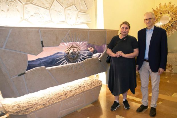 Carlo Acutis' parents standing next to his tomb in Assisi’s Sanctuary of the Renunciation, within the Church of St. Mary Major. 