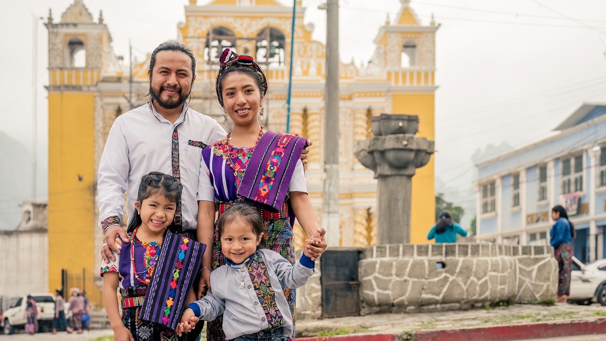 Indigenous Mexican family standing in front of church