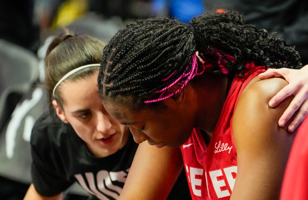 Caitlin Clark speaks to Indiana Fever teammate Aliyah Boston during the WNBA playoffs in Sept 2024
