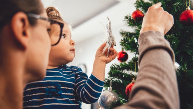 Mom and daughter decorating Christmas tree