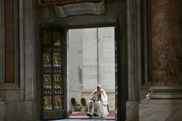 Pope Francis opens the Holy Door of St Peter's Basilica in the Vatican to mark the start of the Catholic Jubilee Year, on December 24, 2024