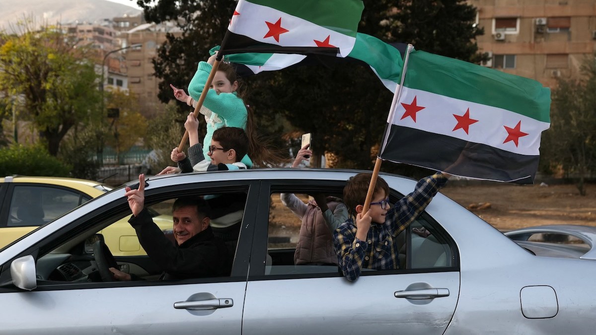 Jubilant Syrians fly flags from car