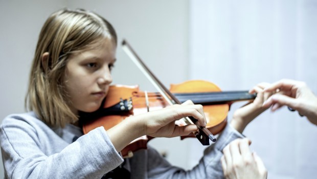 Teacher working with violin student